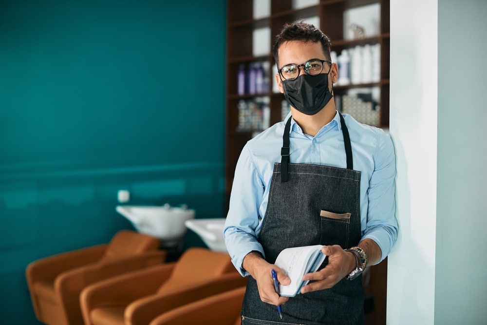 Happy,Hairdresser,Wearing,Face,Mask,While,Working,At,Hair,Salon hair salon during coronavirus pandemic