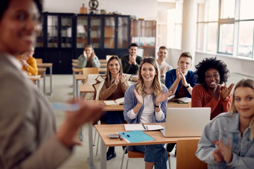 Group,Of,Happy,Students,Applauding,To,Their,Lecturer,While,Attending Group of happy students in a classroom