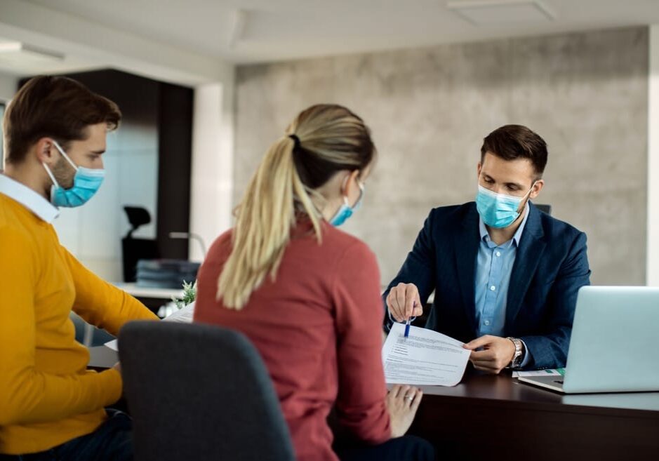 Financial,Advisor,And,A,Couple,Going,Through,Paperwork,While,Having Financial advisor and a couple going through paperwork